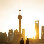 Photo taken in Shanghai during sunset. We see the great tower of Shanghai and 2 journalists taking pictures